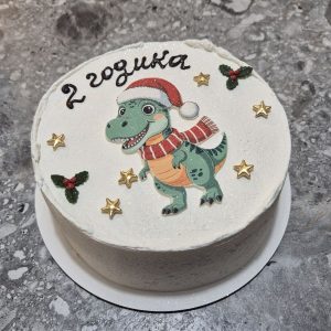 Bento T-Rex „2 godika” în costum Crăciun cu șapcă roșie, eșarfă, ornamente verzi și stele, cremă albă, 660-700g de la Emys Cakes